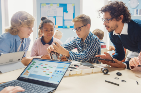 Children in classroom learning coding